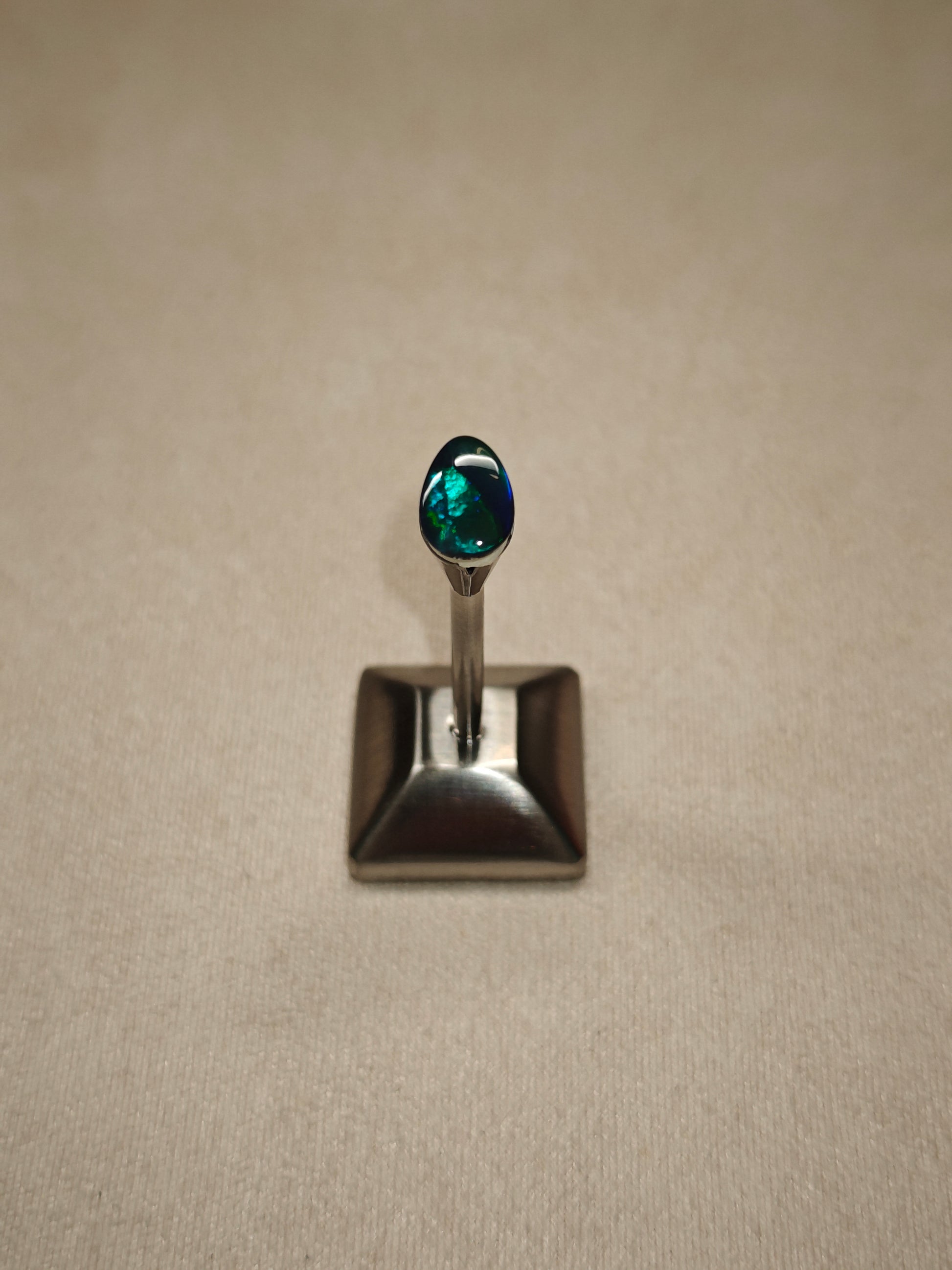 Australian black opal gem with metallic lighting 