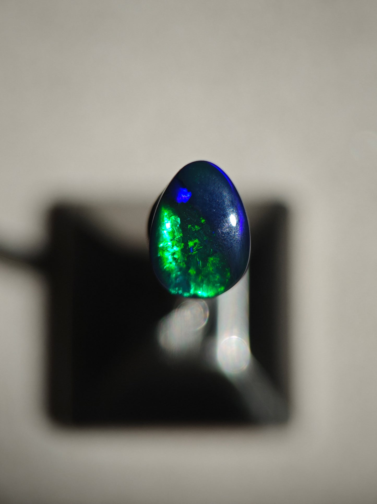 Australian black opal gem with metallic lighting 