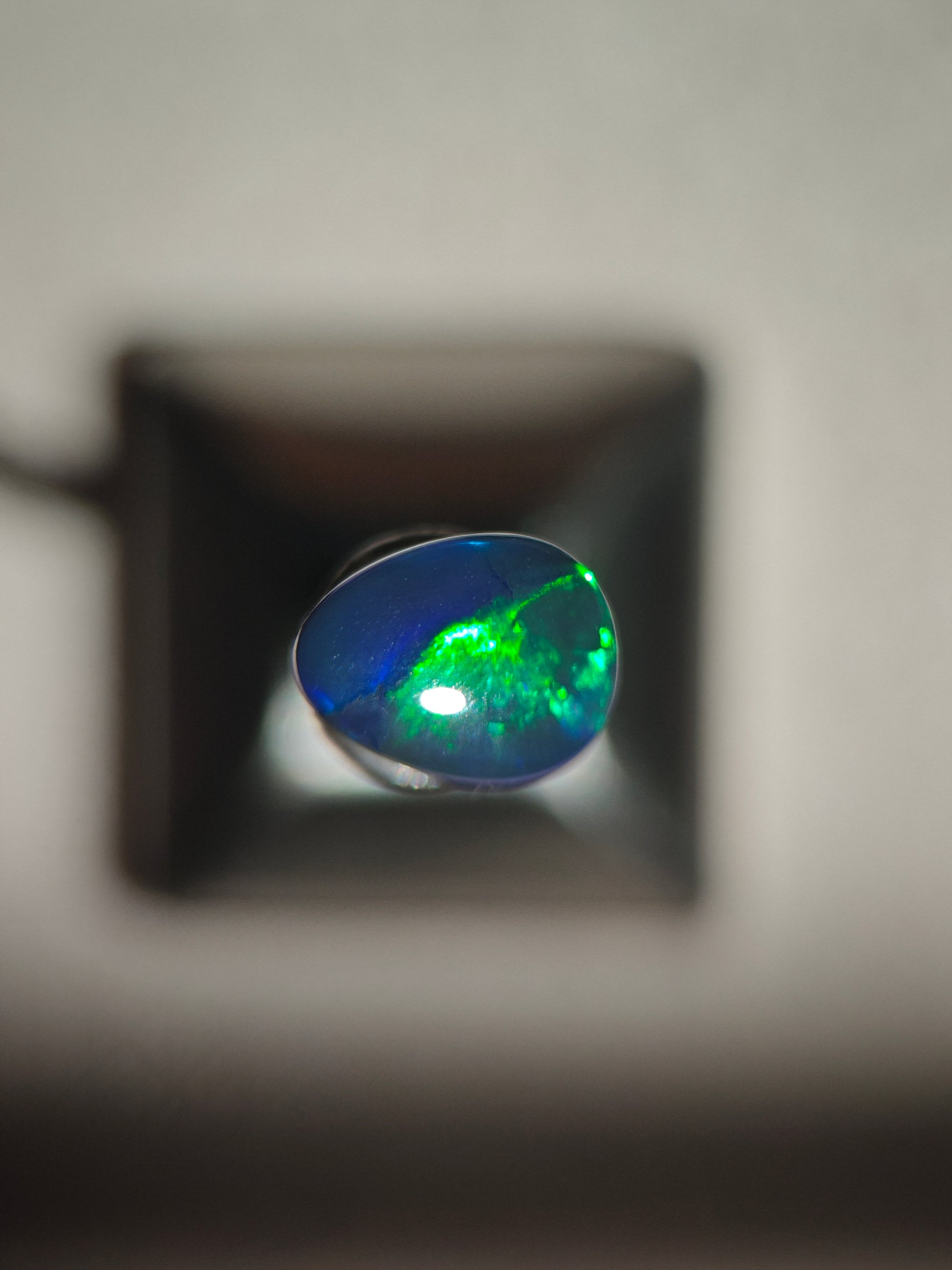 Australian black opal gem with metallic lighting 
