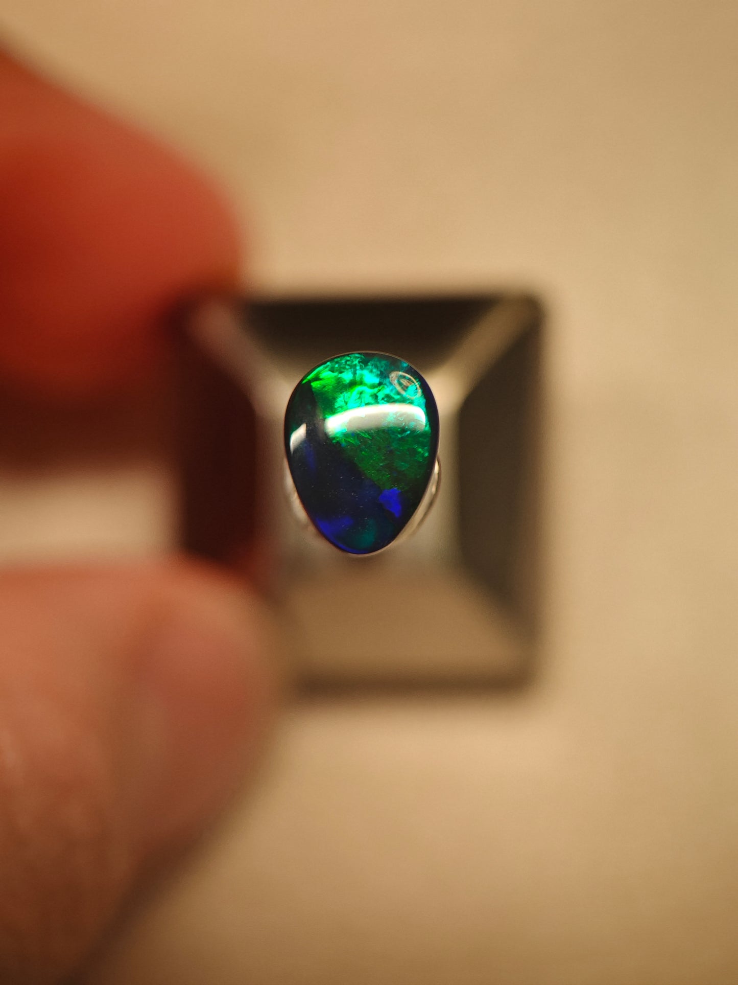 Australian black opal gem with metallic lighting 
