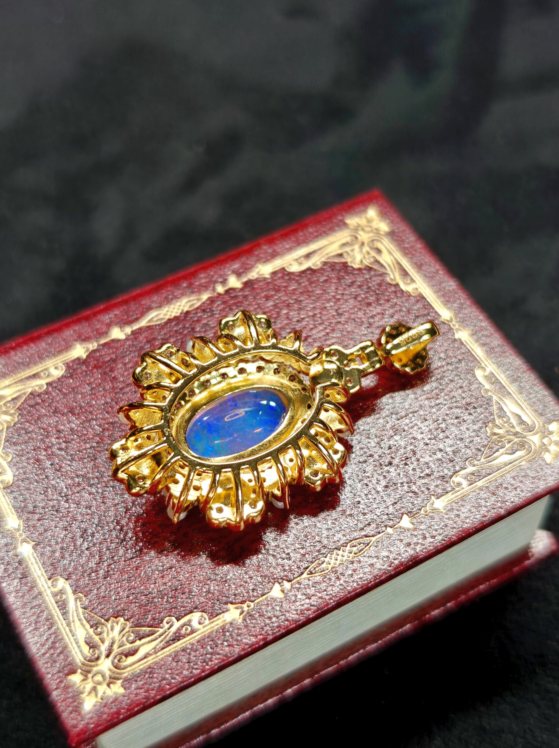 Vintage-style pendant featuring a large central blue crystal opal surrounded by pearls 