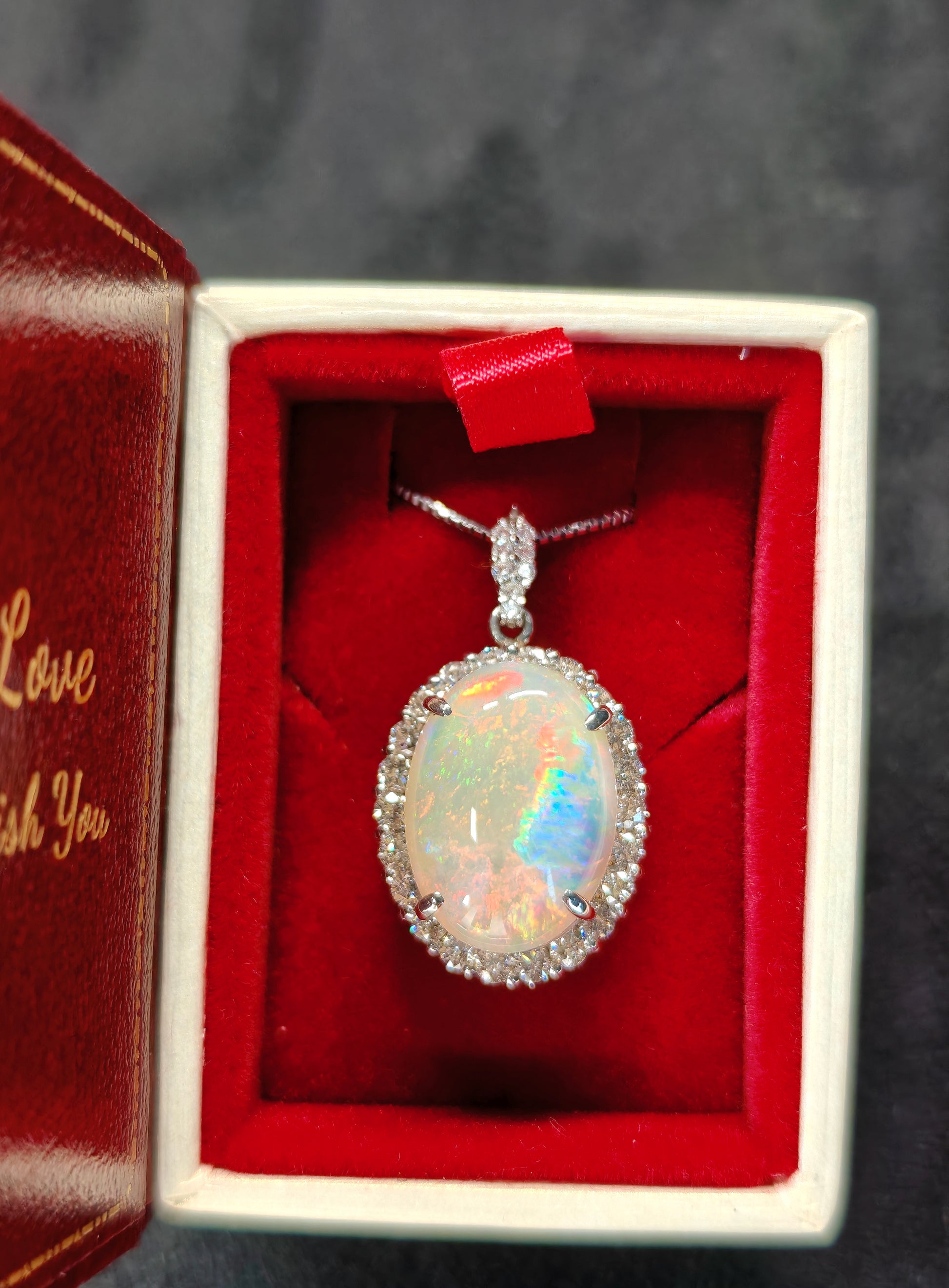Oval crystal opal and diamond halo pendant with diamonds