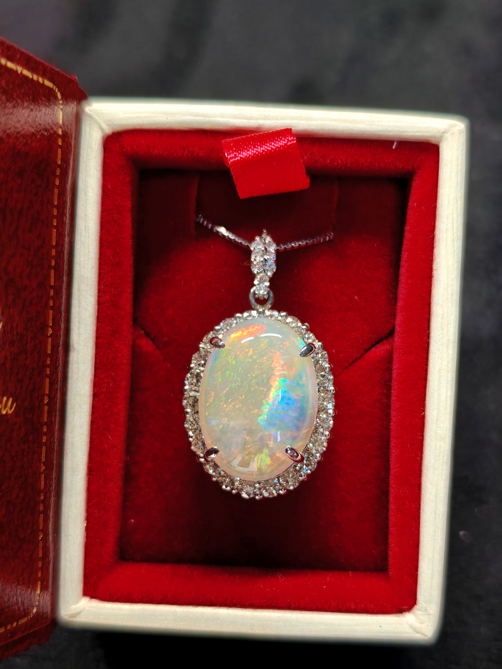 Oval crystal opal and diamond halo pendant with diamonds