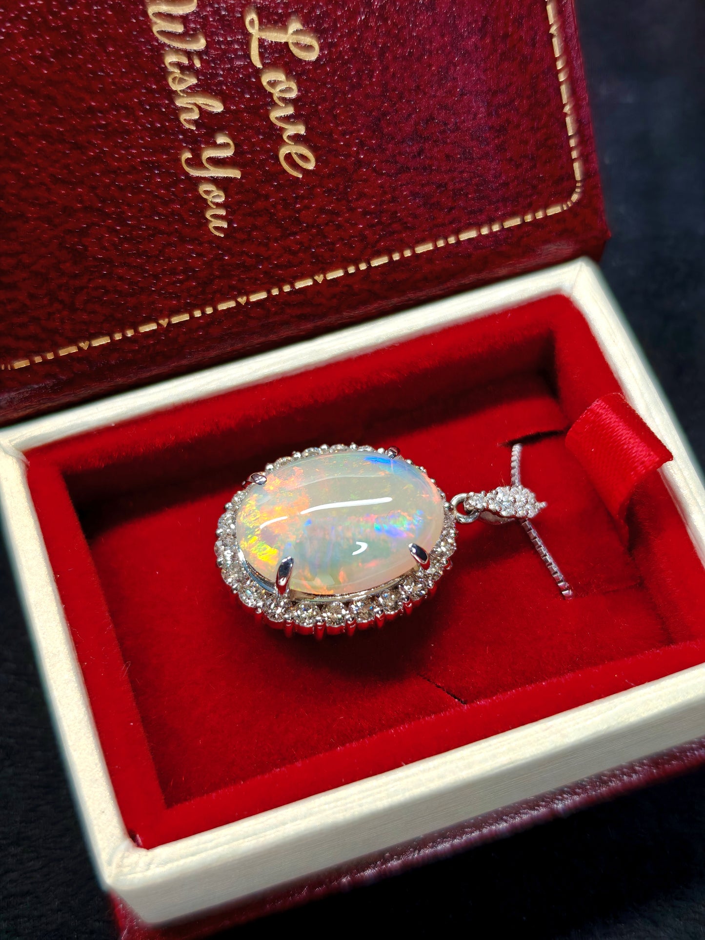 Oval crystal opal and diamond halo pendant with diamonds