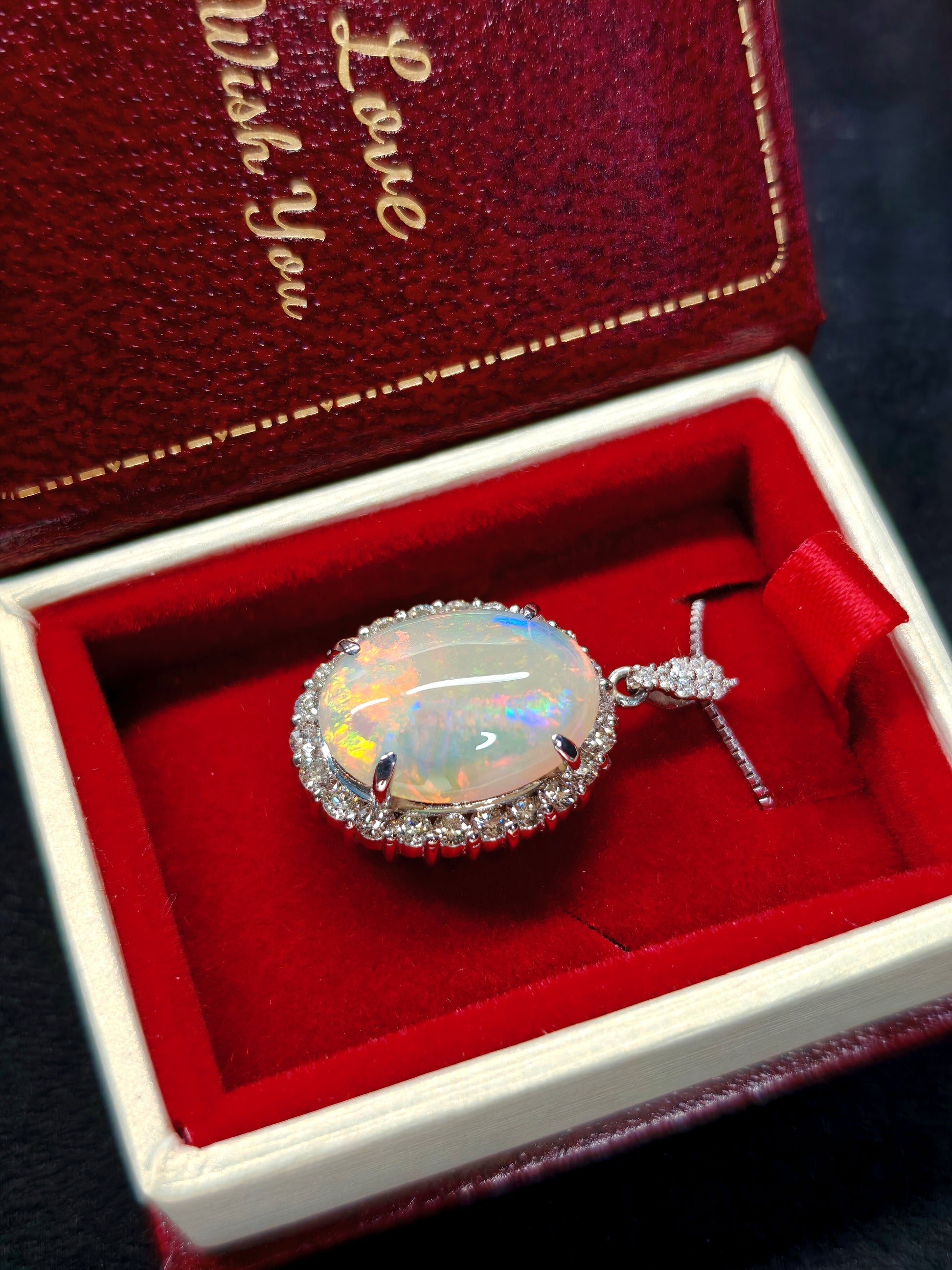 Oval crystal opal and diamond halo pendant with diamonds